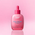 Pink serum bottle with dropper on a pink background